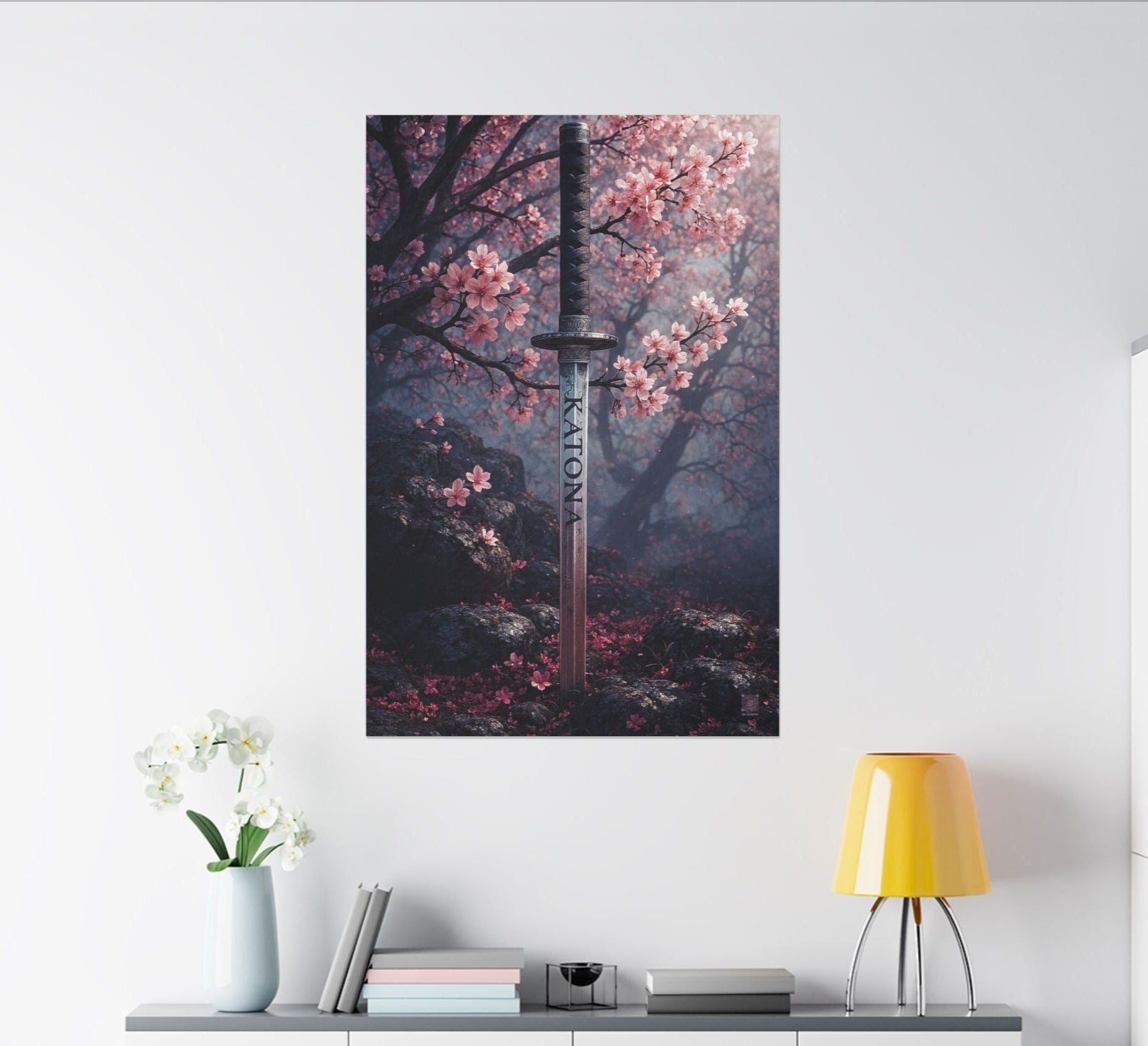 Framed artwork of a sword in cherry blossom branches on a white wall above a shelf with decor items.